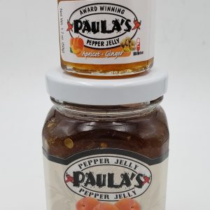 The 1.7 oz. pepper jelly jar on top of the 8 oz. pepper jelly jar from Paula’s Pepper Jelly.