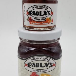 1.7 oz. orange and cranberry pepper jelly jar on top of the 8 oz. Paula’s Pepper Jelly jar label out.
