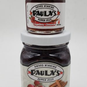 The 1.7 oz. Wild Lingonberry & Cinnamon Pepper Jelly on top of the 8 oz. jar from Paula’s Pepper Jelly.