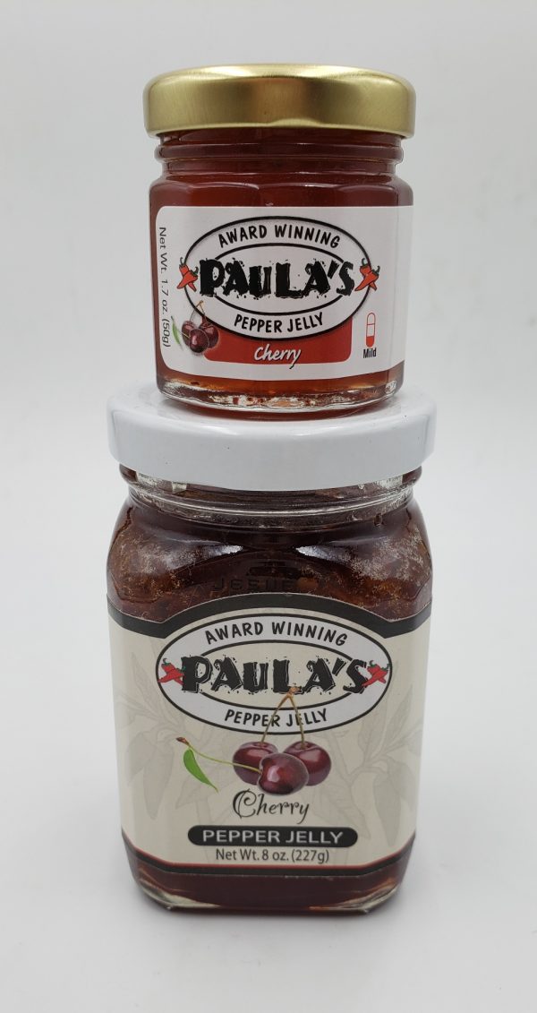One of Paula’s 1.7 oz. pepper jelly jars stacked on top of the 8 oz. best pepper jelly jar from Paula’s Pepper Jelly.
