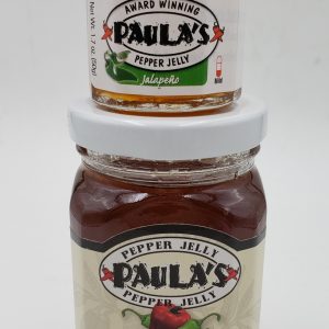 The 1.7 oz. Paula’s Pepper Jelly Jar on top of the 8 oz. Jalapeno Pepper Jelly both label out.