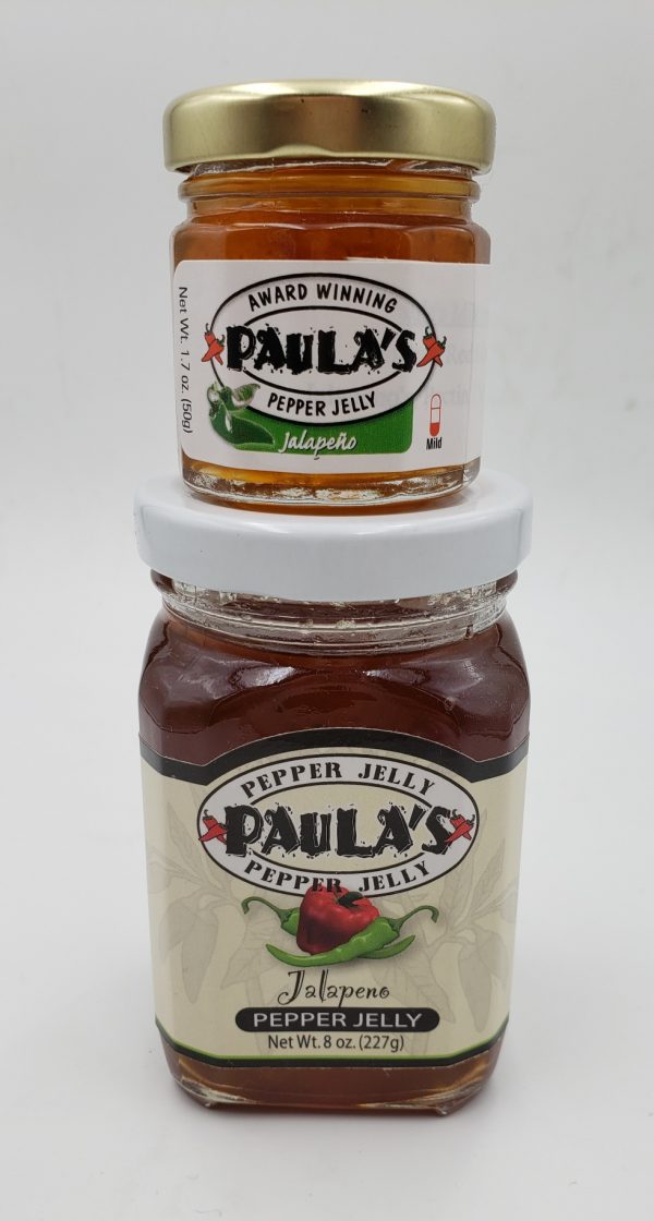 The 1.7 oz. Paula’s Pepper Jelly Jar on top of the 8 oz. Jalapeno Pepper Jelly both label out.
