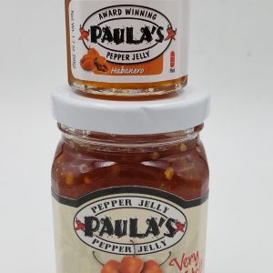 1.7 oz. Paula’s Pepper Jelly jar on top of the full 8 oz. habanero pepper jelly jar. Both labels are facing outward.
