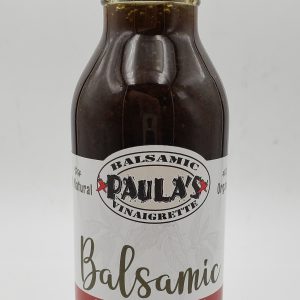 12 oz. bottle of Paula’s homemade balsamic vinaigrette salad dressing from Paula’s Pepper Jelly with the label facing out.