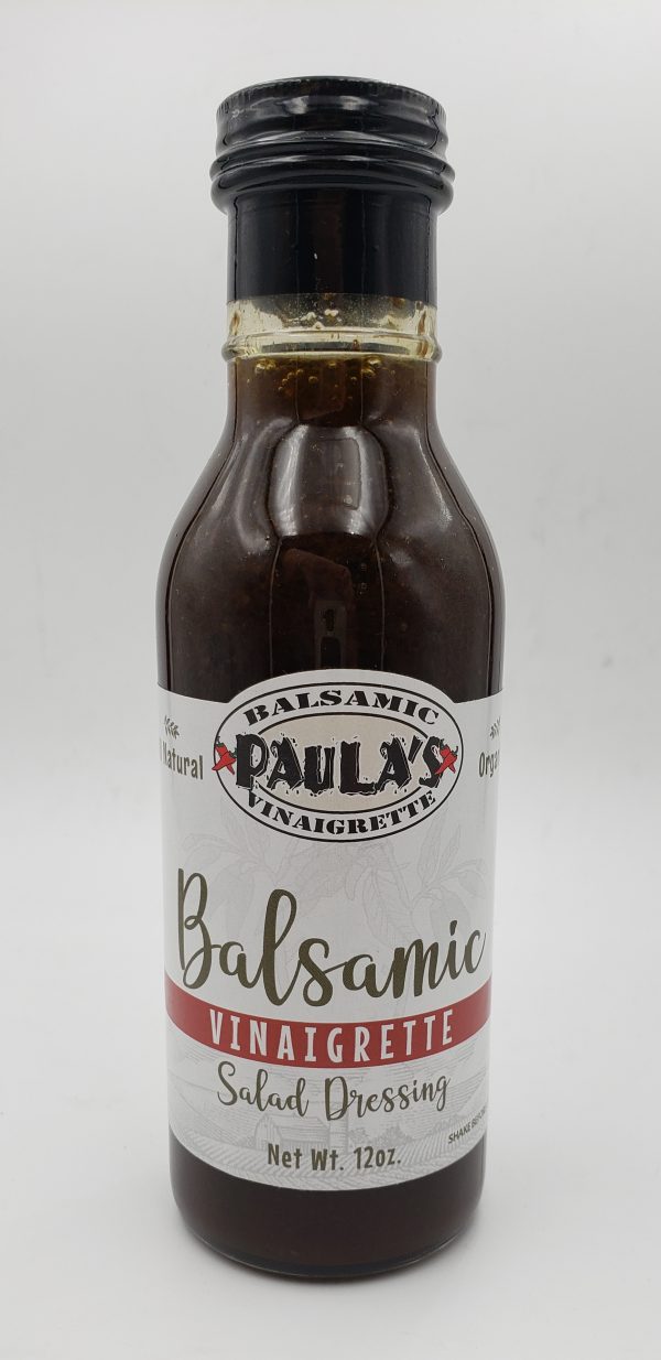 12 oz. bottle of Paula’s homemade balsamic vinaigrette salad dressing from Paula’s Pepper Jelly with the label facing out.